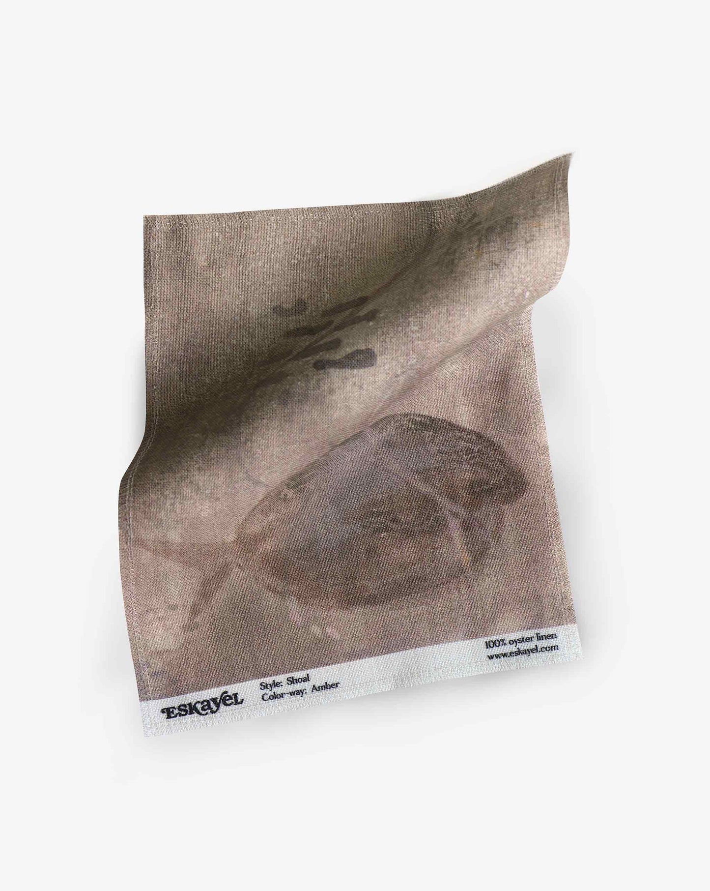 A swatch image of Eskayel’s Shoal print in the colorway Amber on linen fabric incorporating tones of brown.