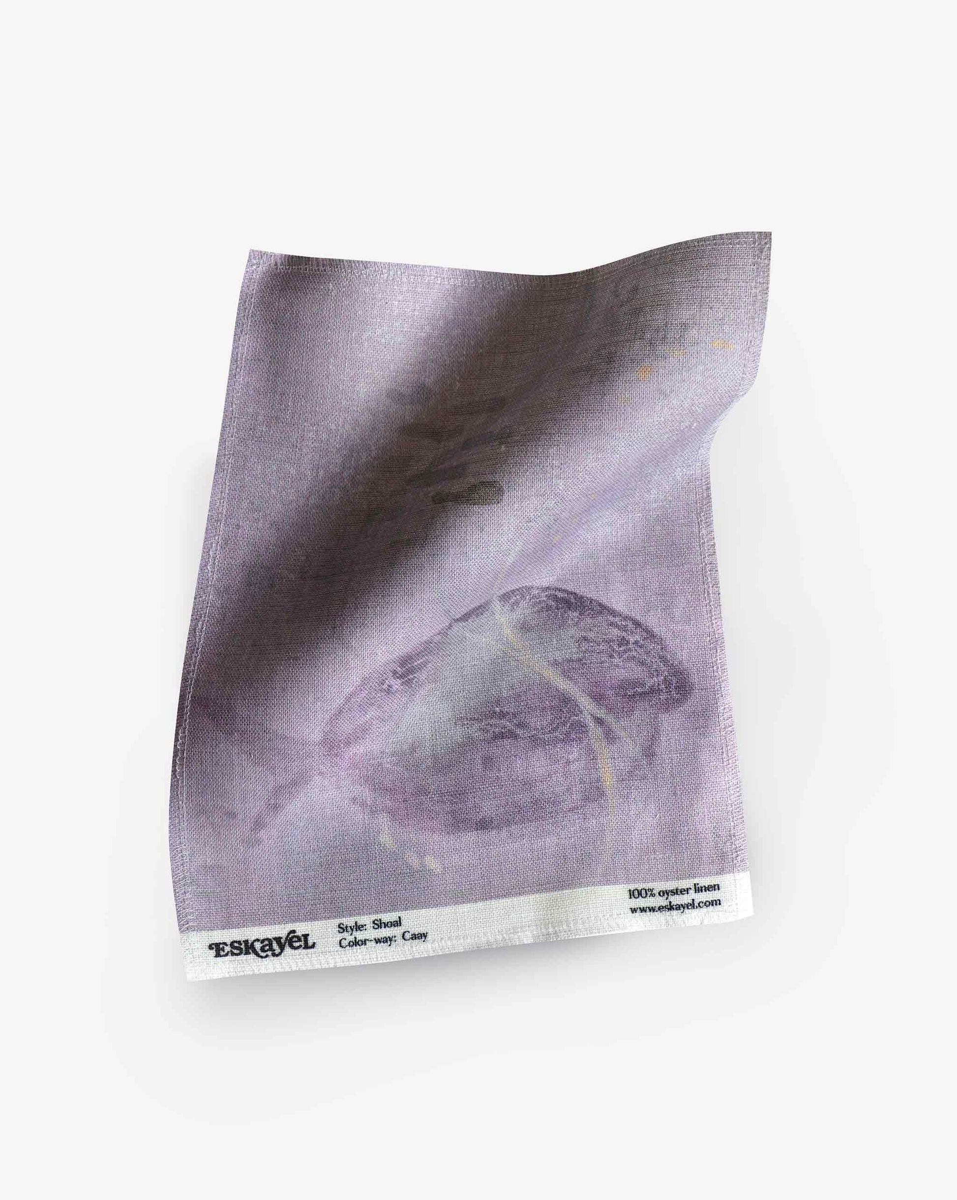 A swatch image of Eskayel’s Shoal print in the colorway Cay on linen fabric incorporating tones of purple.