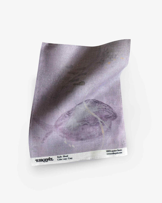 A swatch image of Eskayel’s Shoal print in the colorway Cay on linen fabric incorporating tones of purple.