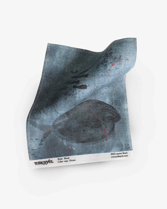 A swatch image of Eskayel’s Shoal print in the colorway Ocean on linen fabric incorporating tones of blue.