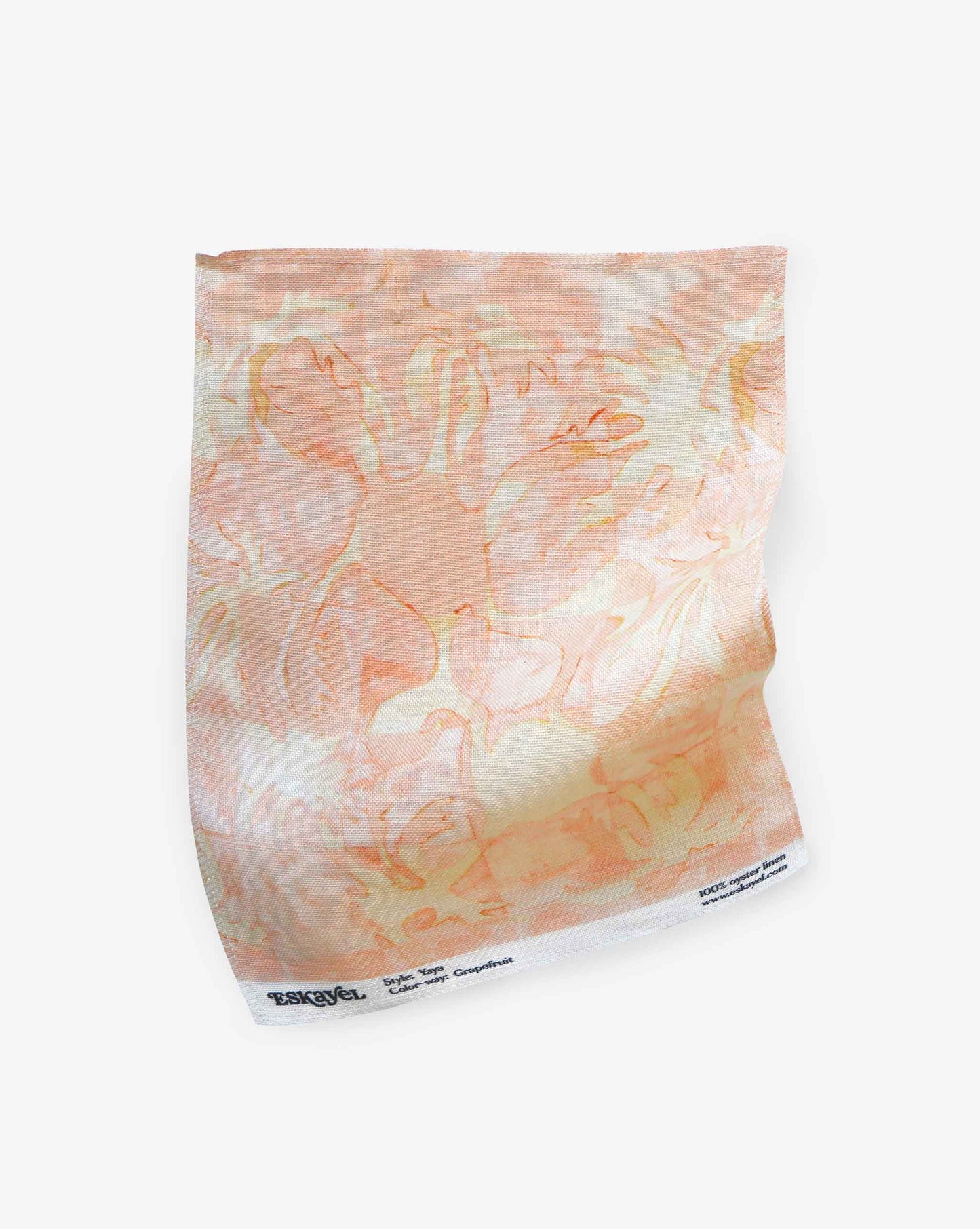 Yaya fabric in Grapefruit as a swatch — beach-themed graphic botanical fabric in pale peach with highlights of light yellow | Eskayel