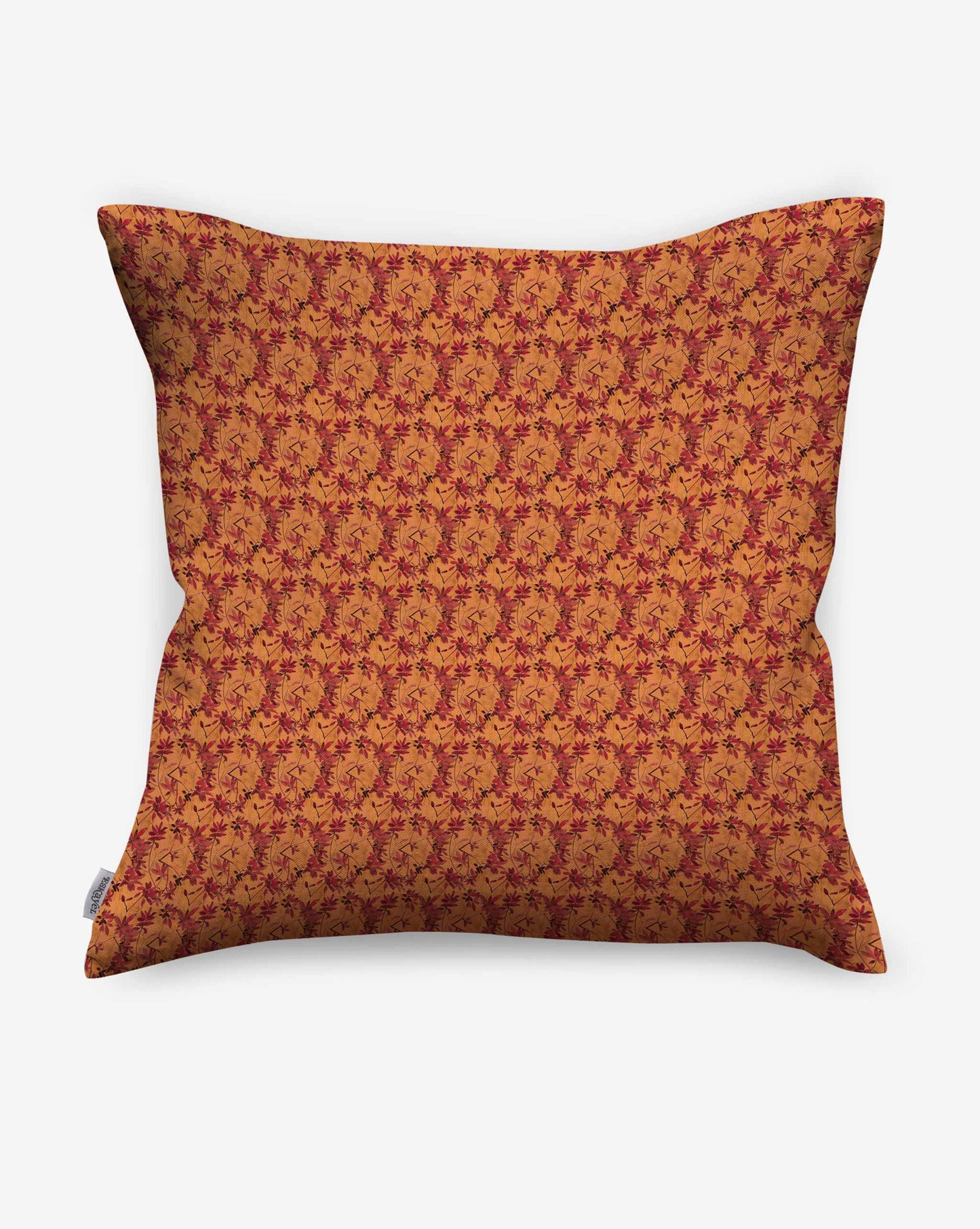 Pillows in Eskayel’s Alhelí, a tiny repeating pattern inspired by tropical living, in the orange-based colorway Golden Hour.