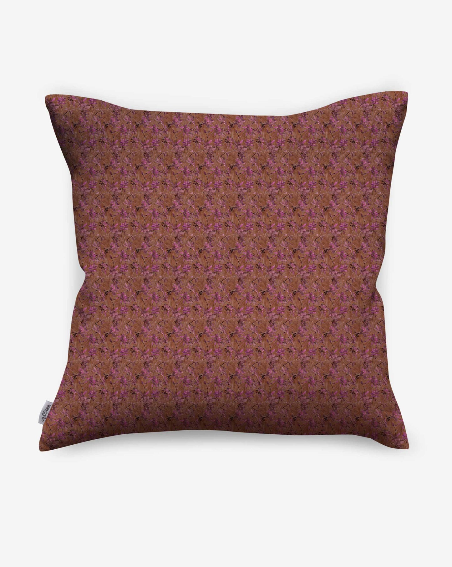 A pillow in Eskayel’s Alhelí fabric, a tiny repeat pattern inspired by tropical light, shown in the brown-based Rubra colorway.
