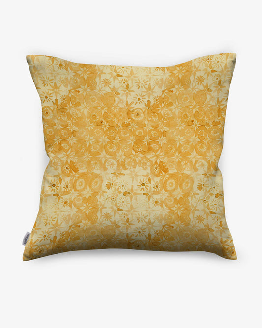With a watercolor pattern of flowers on squares, Crochet Lace pillows in Limoncello reference handmade lace in warm yellow hues.