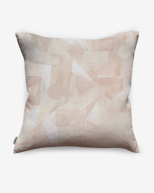 In Pieces pillows in Quartz, beige blocks of pigment depict puzzle pieces.