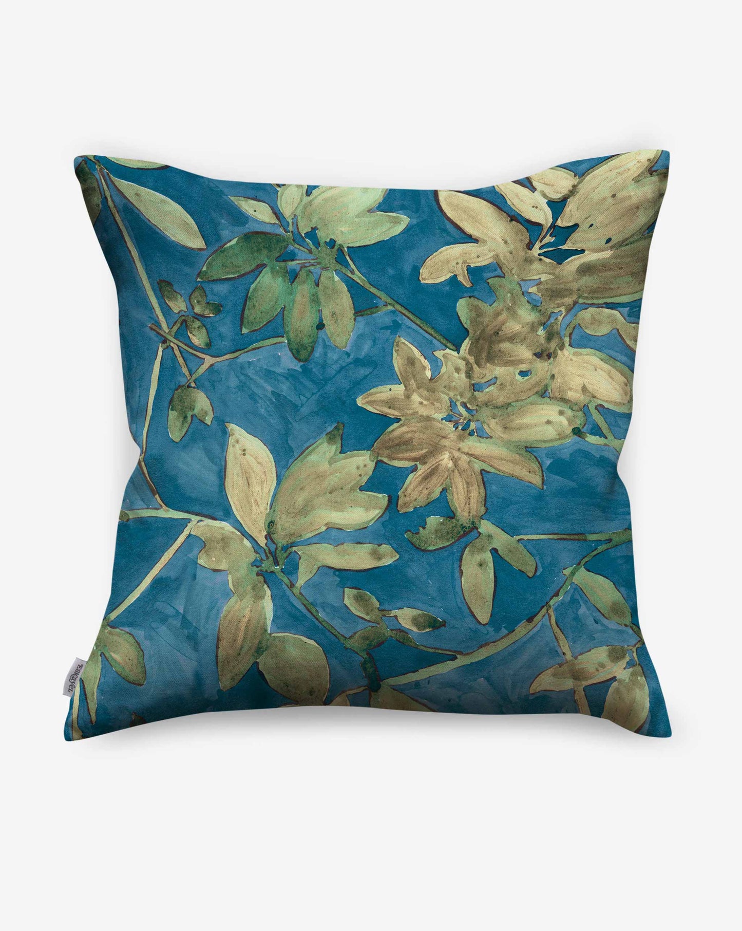 A photo of Eskayel’s Plumeria Shadows pillow pattern in Tide Pool, a colorway featuring a deep blue background.