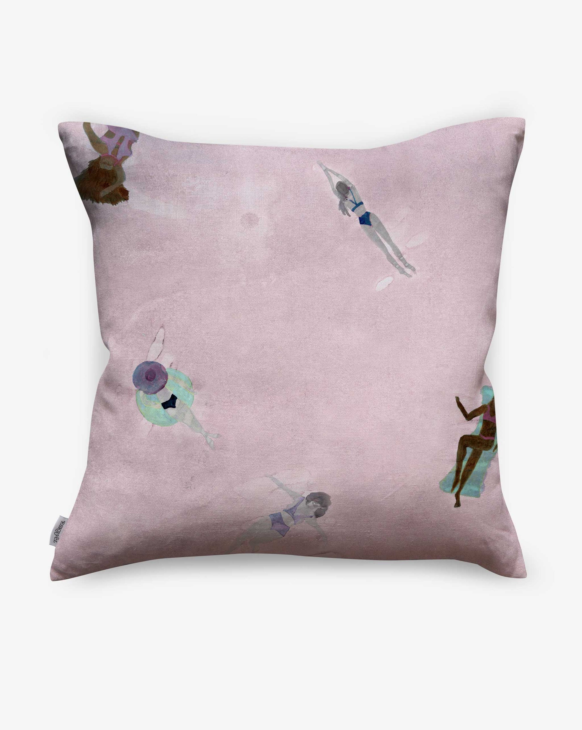 The Swim Pillow in Shell features a pink background with abstract watercolor art of people swimming and lounging, making it the perfect charming accent for your beach house.