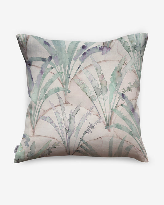 Depicting palms repeated against a scallop background, Travelers Palm pillows in Dusk use a palette of green and beige