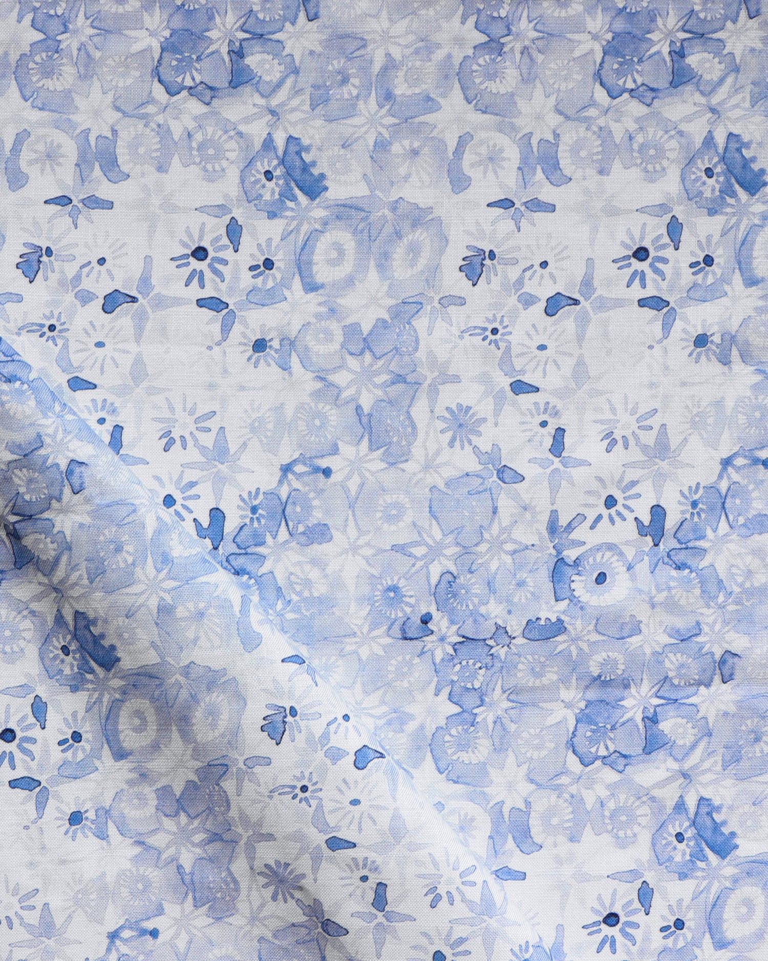 Floral patterned fabric with blue flowers on a white background