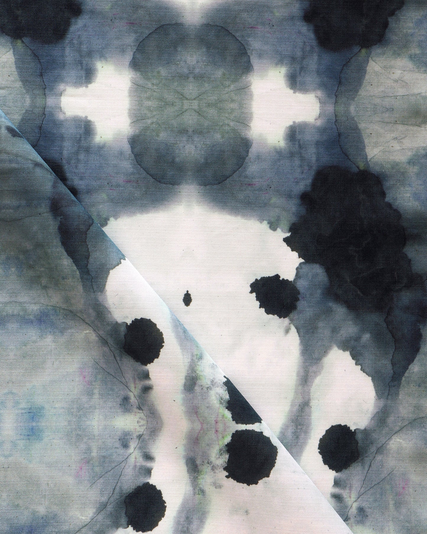 A close up of a black and white ink stain on a piece of Dynasty Performance Fabric Indigo