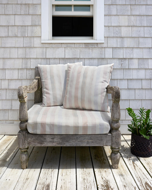 A chair upholstered in Eskayel's Gradient Stripe performance fabric in the color way pink island.