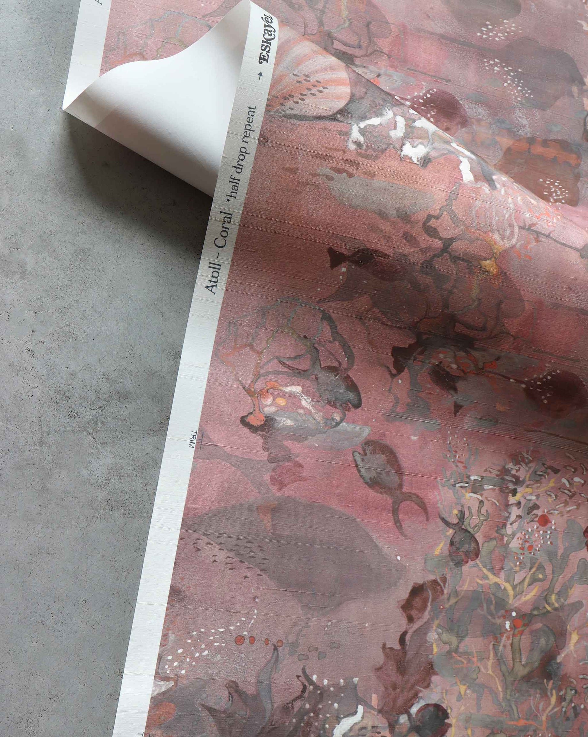 A close up detailed shot of Eskayel’s Atoll wallpaper in Coral with its red hues.