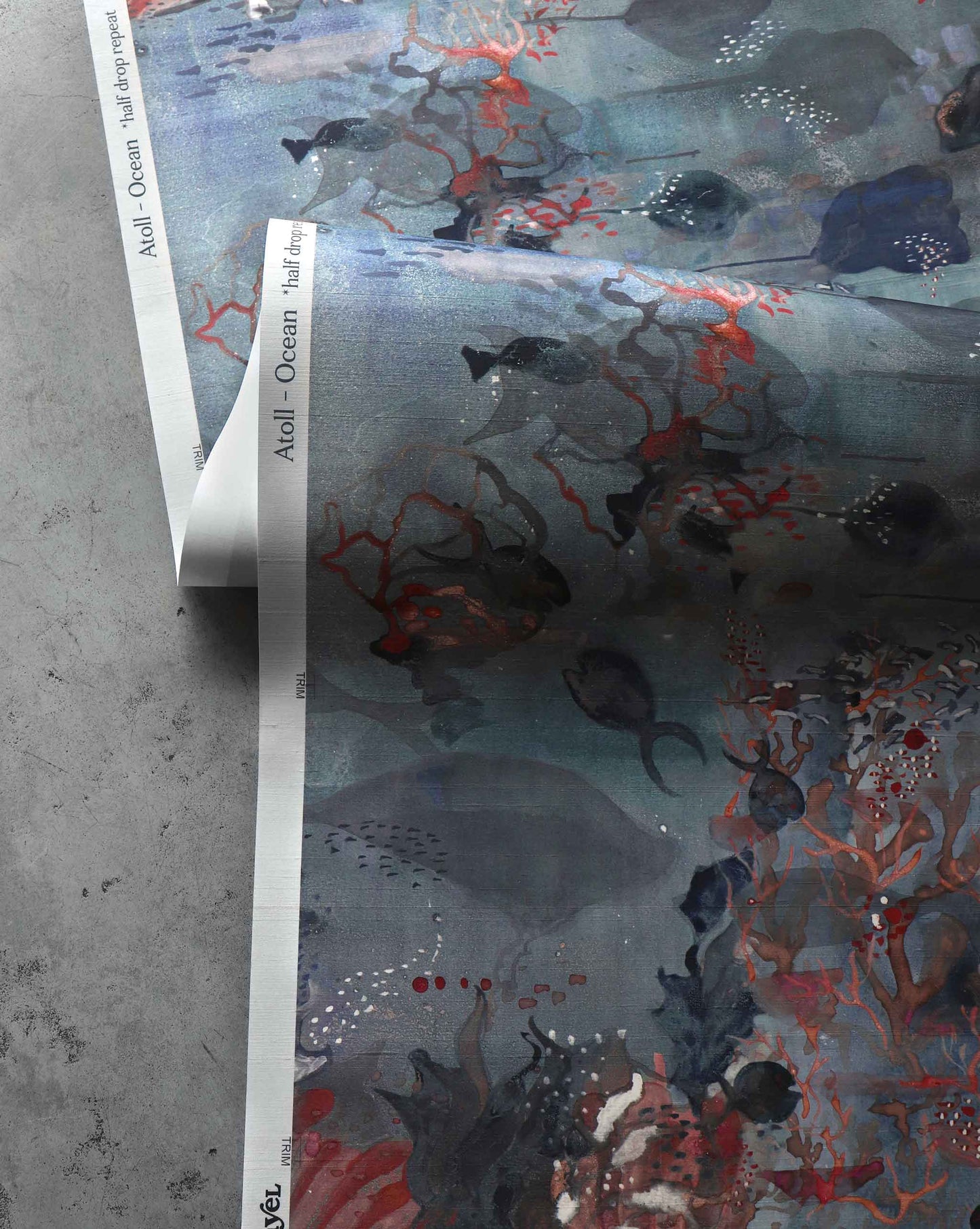 A close up detailed shot of Eskayel’s Atoll wallpaper in the colorway Ocean with its blue hues.