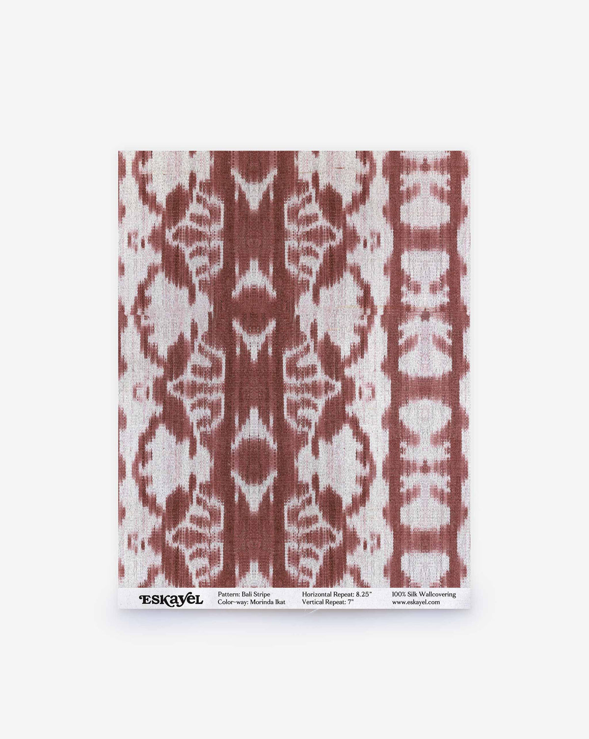 A rectangular swatch of Bali Stripe Silk Sample||Morinda Ikat wallpaper featuring a rust-colored ikat stripe pattern, with label text at the bottom and an Order Sample button.