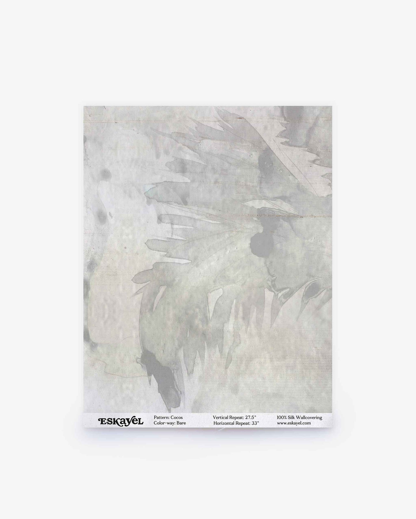 A square sample of Cocos Silk wallpaper in the Bare colorway displays light gray abstract, feather-like brushstroke patterns with a subtle watercolor texture. The label at the bottom features product details and the Eskayel brand—ideal for previewing this luxurious design before ordering a sample for your space.