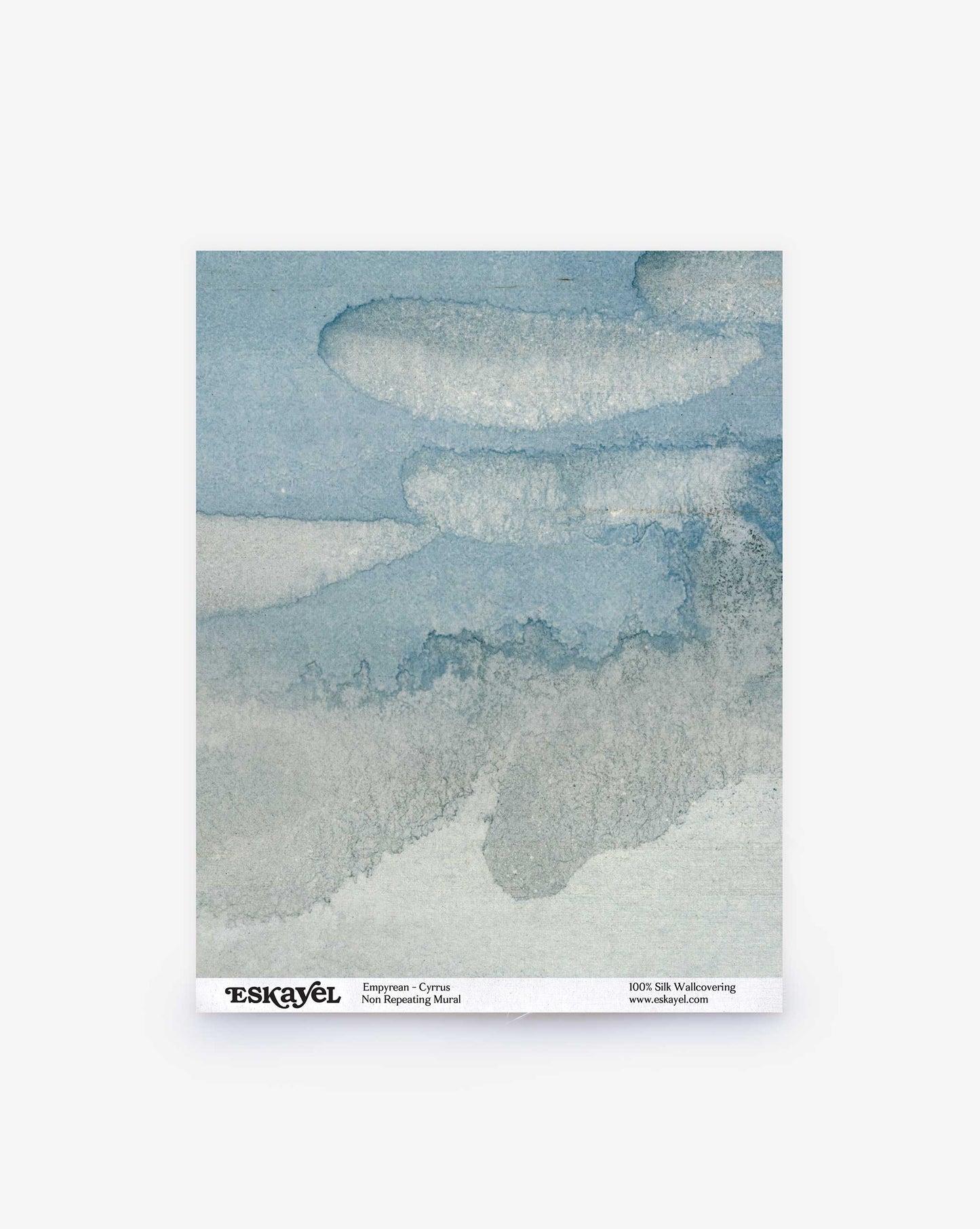 The Empyrean Silk Mural wallcovering sample in Cyrrus is an abstract watercolor featuring layers of blue and gray, resembling clouds and landscapes akin to Maldivian sunrises and sunsets.