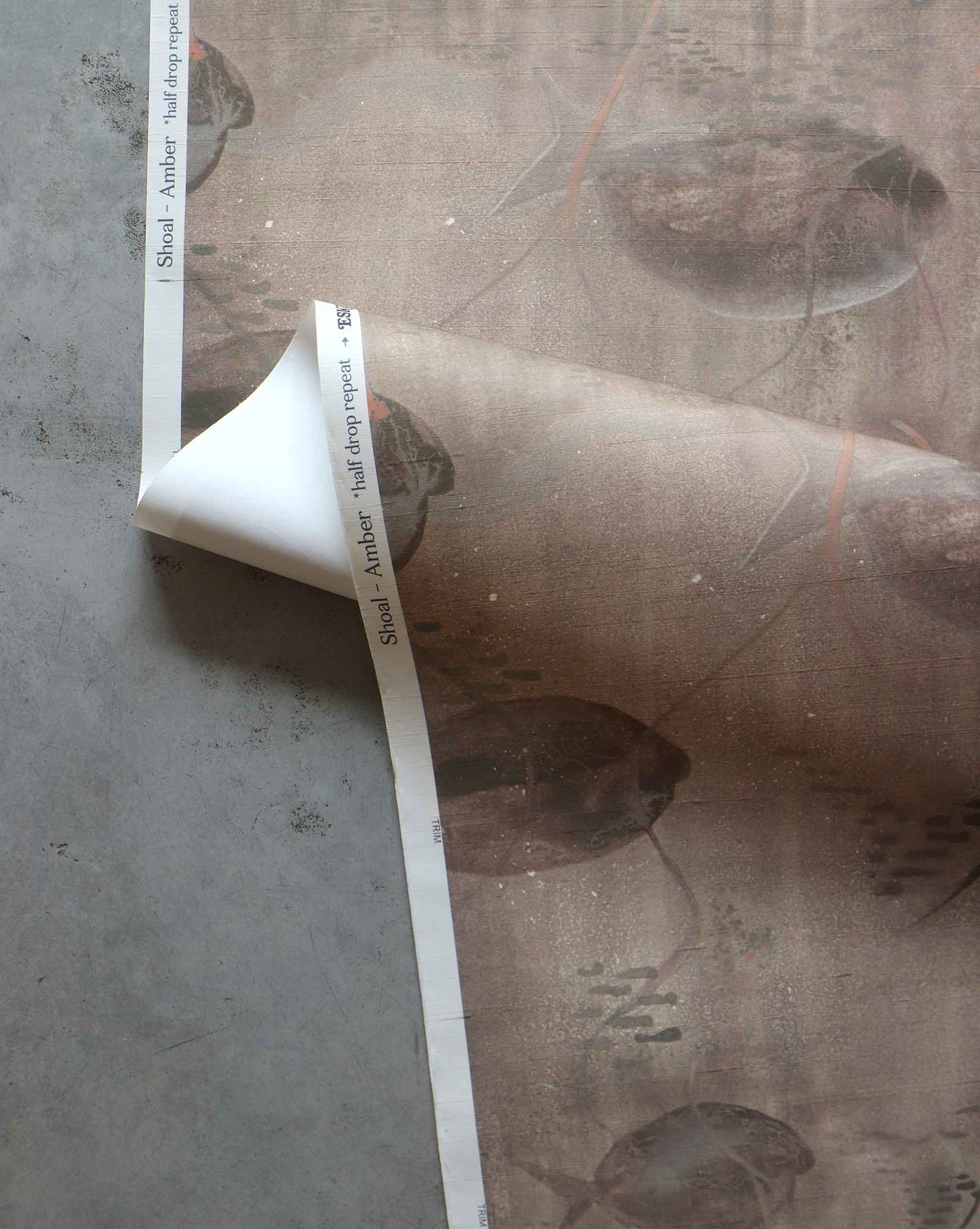 A detailed shot of Eskayel’s Shoal wallpaper in the colorway Amber with its brown hues.