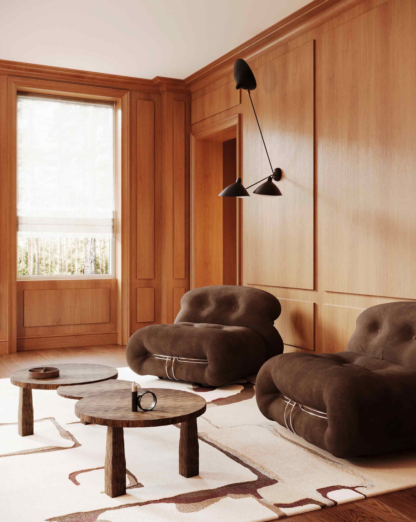 Eskayel’s Neighbors rug in Sienna with its multi-hued colorway is installed in a living room with two brown chairs and a staggered coffee table.