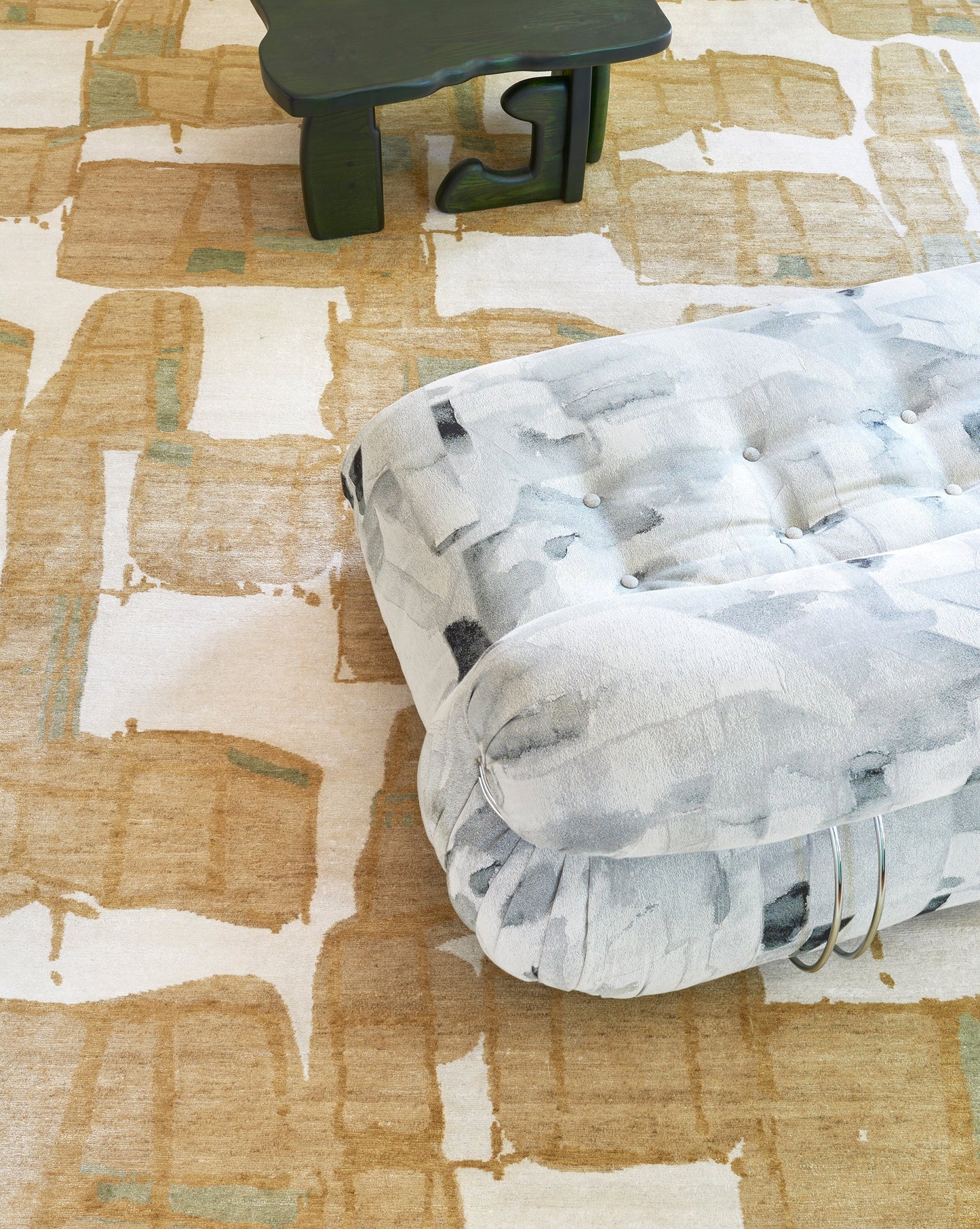 A couch and a chair with a Quotidiana Hand Knotted Rug 9' x 12' Sage design in a room