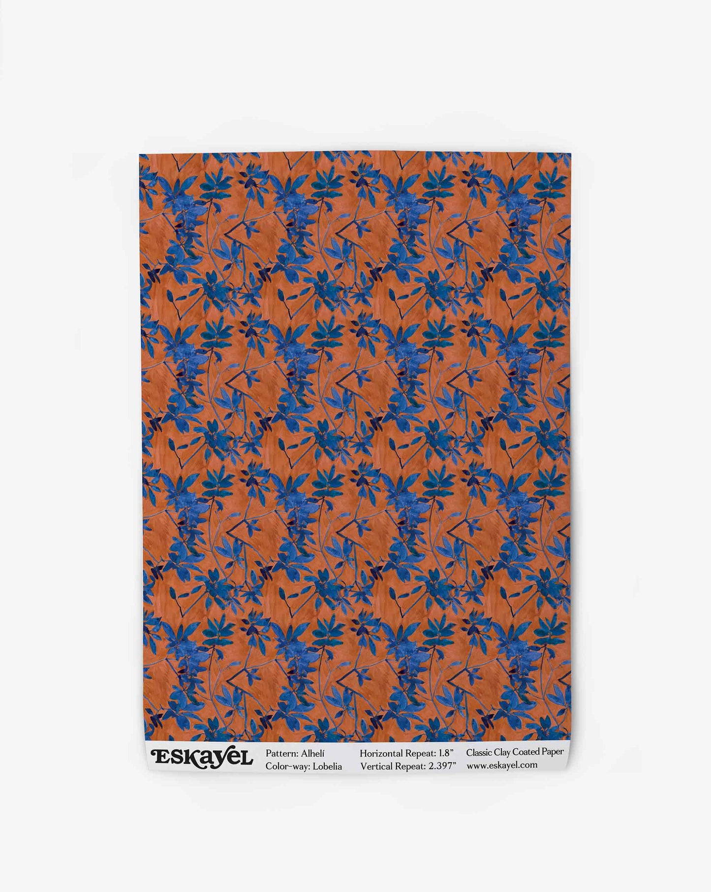 A swatch of Eskayel’s Alhelí wallpaper, a tiny repeating pattern inspired by tropical living in the red-based Lobelia colorway.