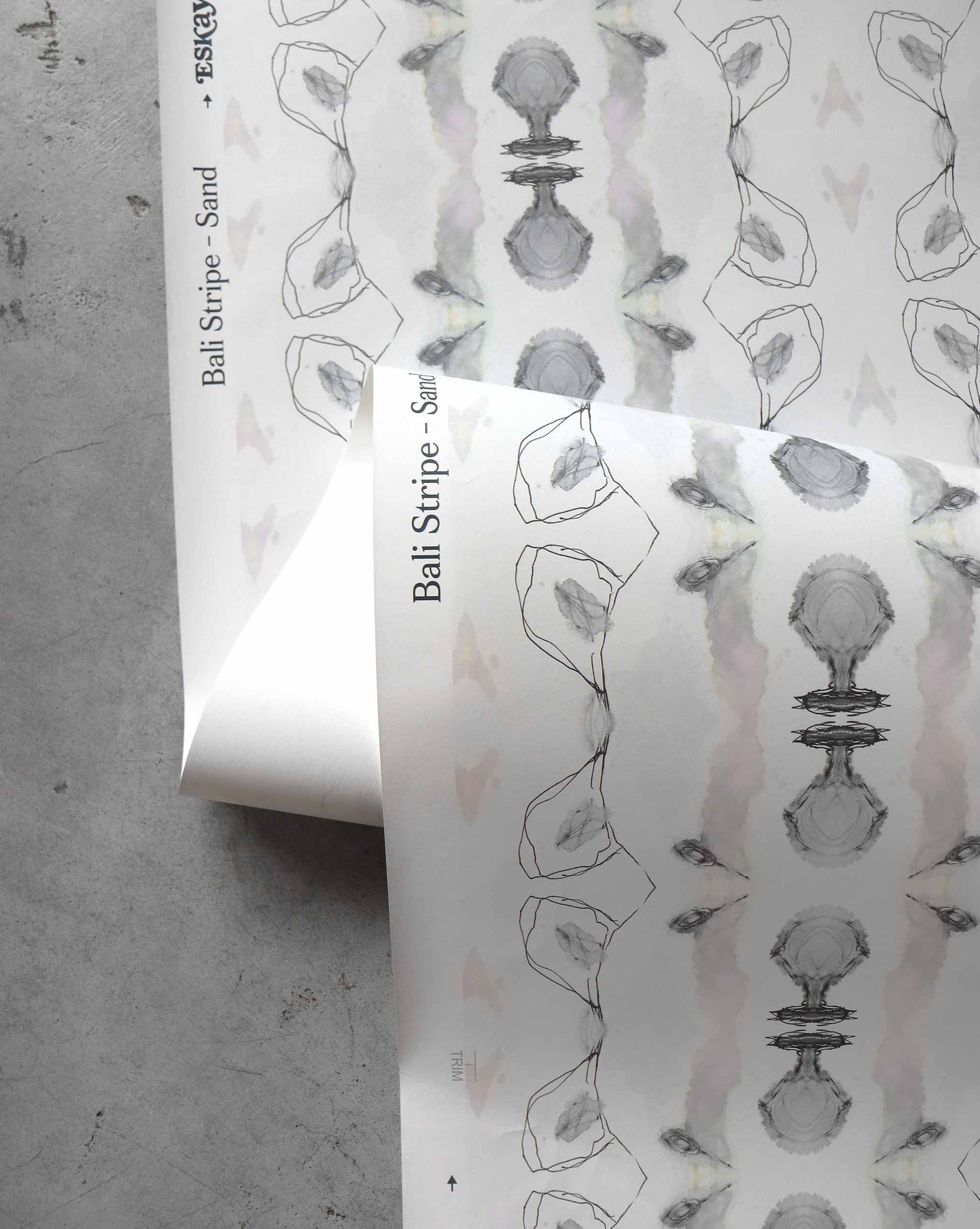 A detail shot of Bali Stripe Wallpaper in the colorway Sand which features white, grey, and beige hues.