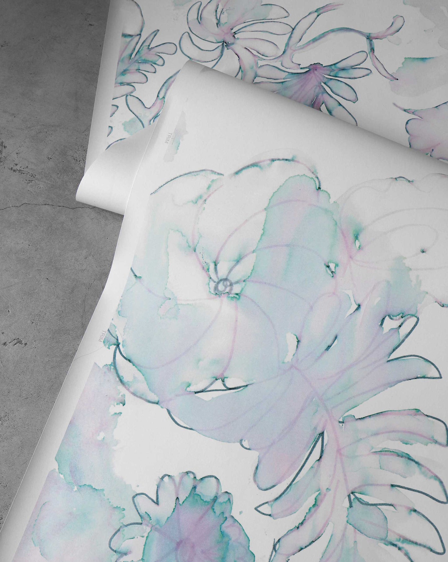 A detail shot of Eskayel's Belize Blooms Wallpaper Mural in the colorway Jardin with delicate blue and green watercolor flowers.