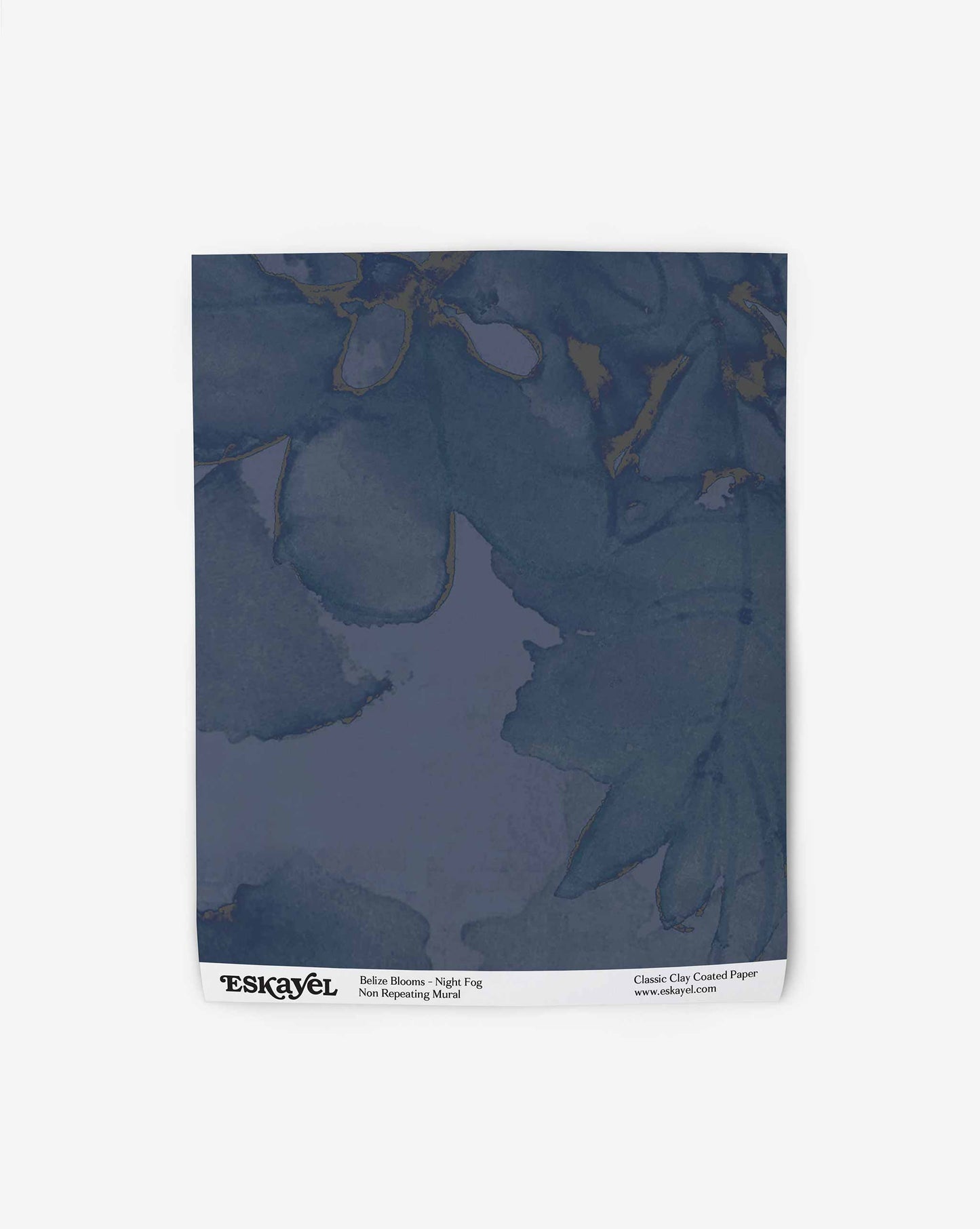 A sample of Belize Blooms Wallpaper Mural||Night Fog featuring a classic blue-gray colored pattern with subtle floral outlines, displayed on a plain background with the brand’s logo at the bottom.