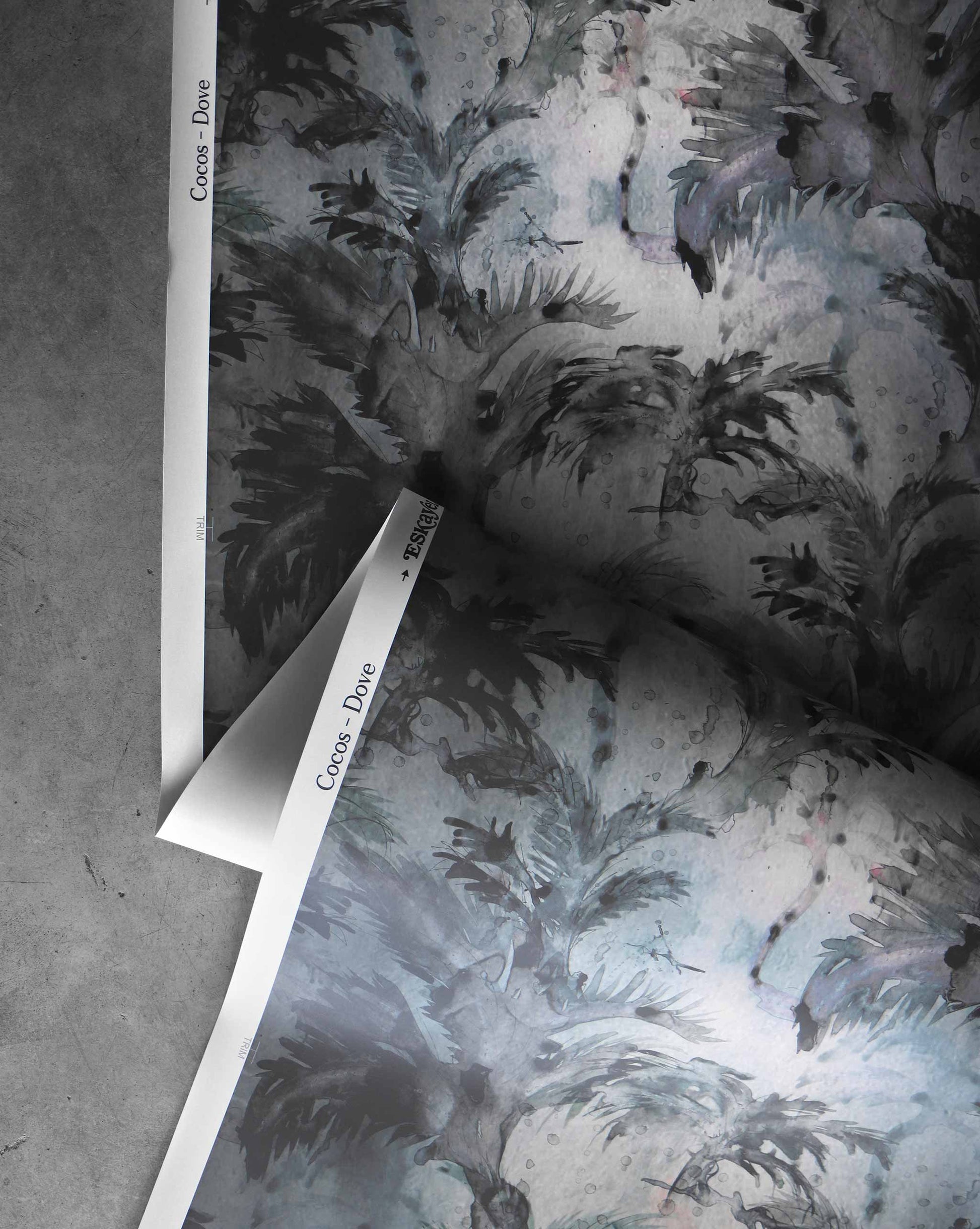 A detail shot of Cocos Wallpaper in the colorway Dove which features a muted multicolored hue.
