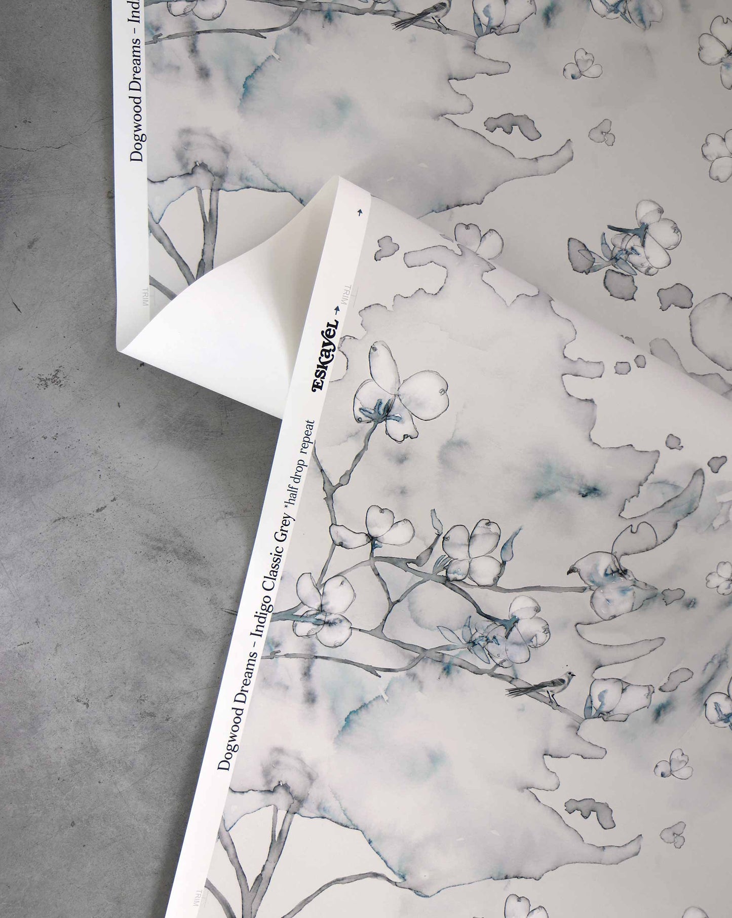 Dogwood Dreams wallpaper in Indigo Classic Grey was inspired by East Coast nature in spring. It provides a pattern in beige and blue.