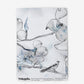 A blue and white Dogwood Dreams Wallpaper Indigo colorway wallpaper with birds on a branch