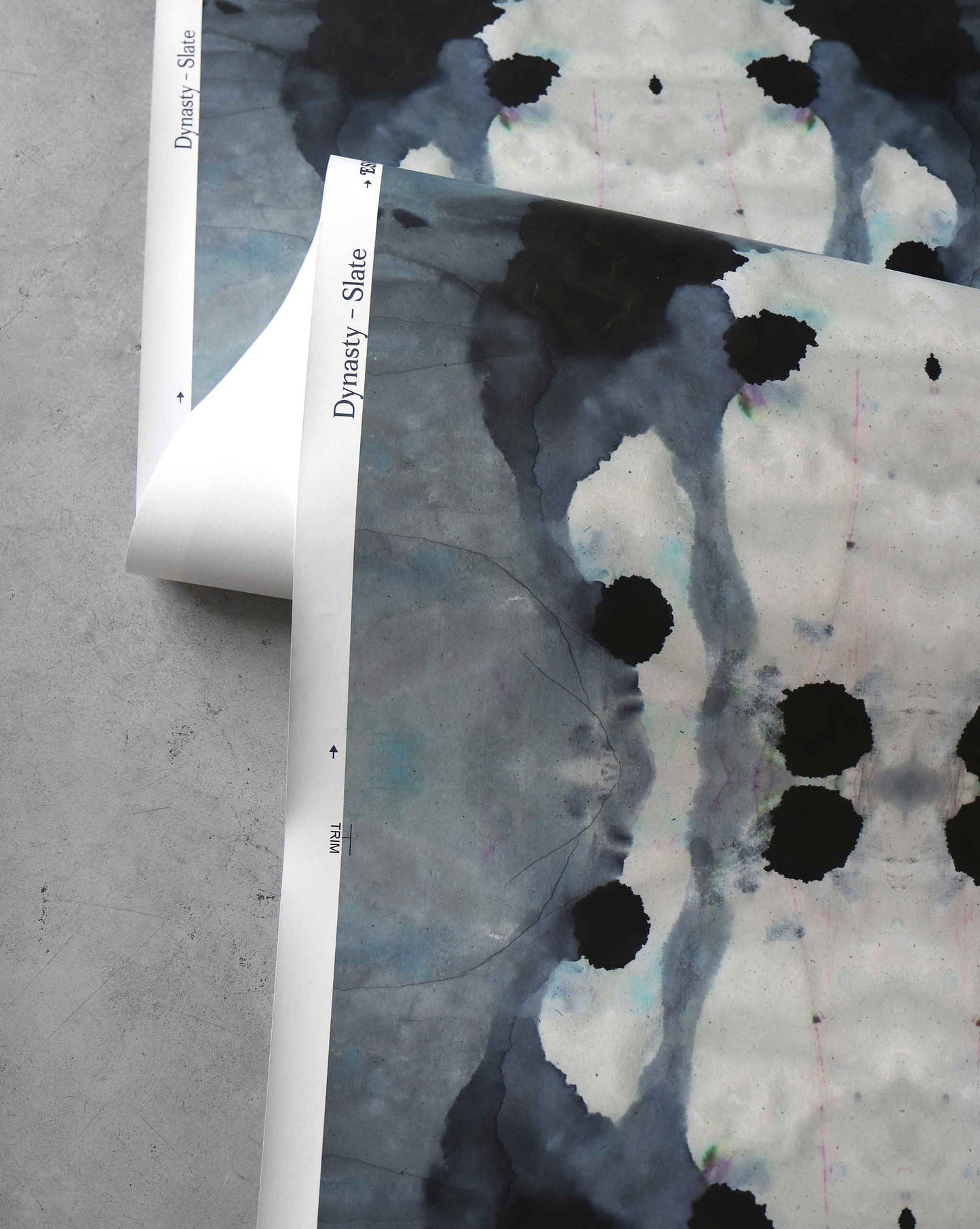 A detail shot of Eskayel's Dynasty wallpaper in the colorway Slate has a black and blue palette.