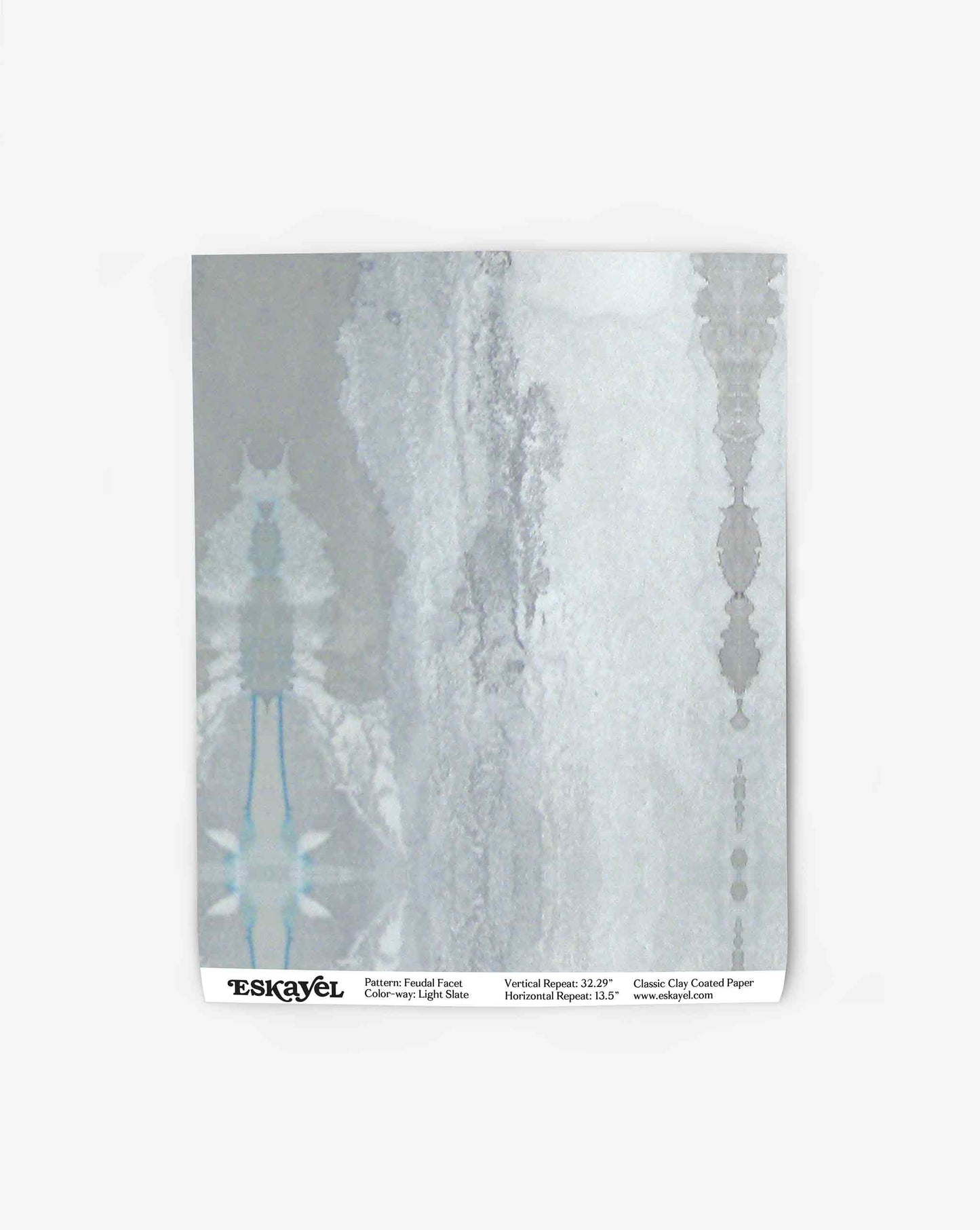 A sheet of Feudal Facet Wallpaper||Light Slate featuring a pastel abstract pattern reminiscent of Tuscany, with a vertical repeat of 32.25 inches and horizontal repeat of 18.5 inches, in colorway light blue.