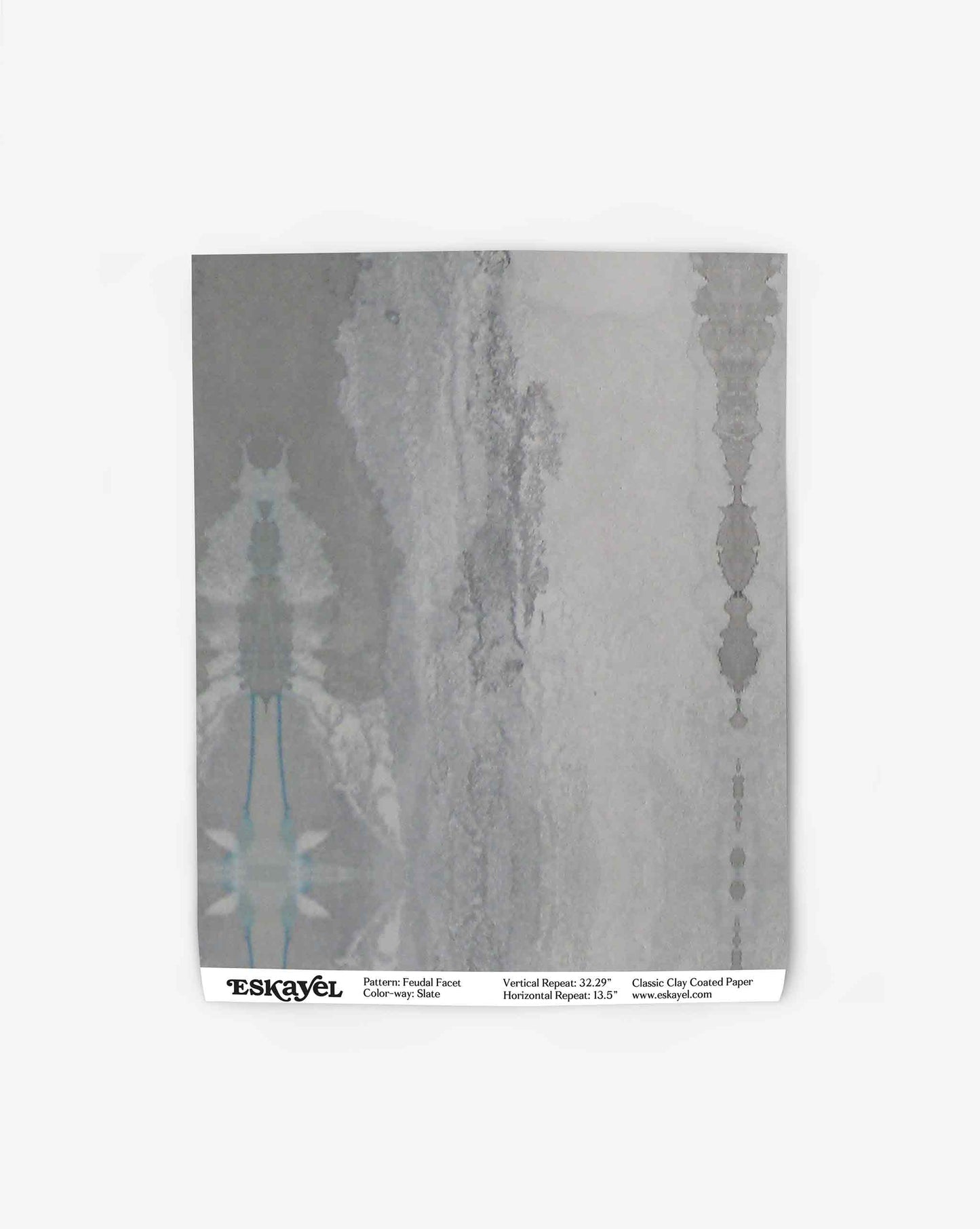 A sheet of Feudal Facet Wallpaper||Slate with a textured gray pattern and turquoise accents, inspired by Tuscany fabric and wallpaper design, printed on classic clay-coated paper.