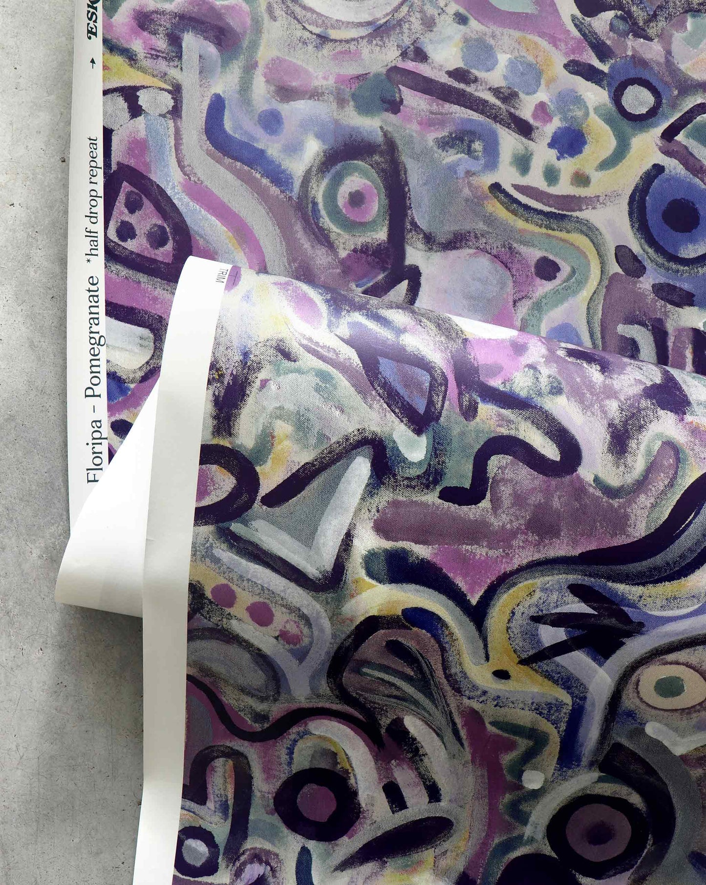 An image of Floripa Pomegranate Wallpaper with purple tones with hints of yellow and blue. The pattern is inspired by the beautiful tropical island of Florianopolis in Brazil.