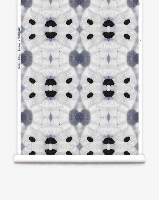 A high-end wallpaper with a striking symmetrical geometric design featuring abstract black and gray shapes on a white background. The Galileo Glass Wallpaper||Indigo design, which repeats vertically and horizontally, brings an elegant touch to any space.
