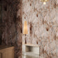 Eskayel's Hibiscus Lily Amber wallpaper is a palette of beige, grey, and brown installed in a hallway.