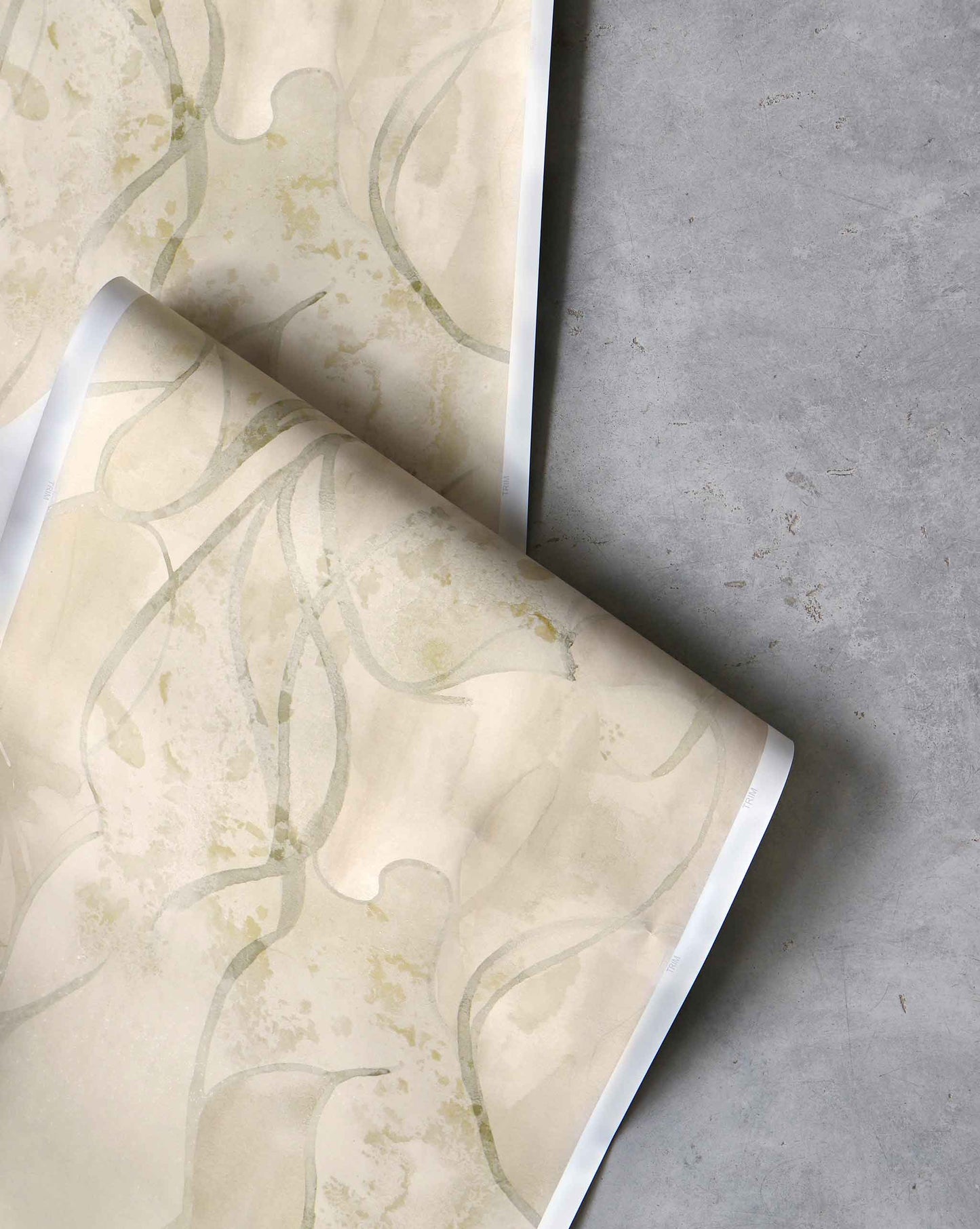 An image of Hibiscus Lily Pearl Wallpaper with beige and yellow hues and a pattern that conveys the overlapping petals slowly unfurling to produce a peaceful mood grounded in nature.