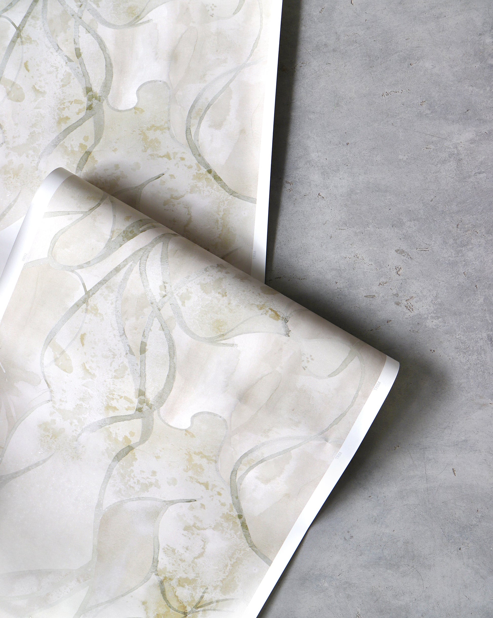 An image of Hibiscus Lily Pearl Wallpaper with beige and yellow hues and a pattern that conveys the overlapping petals slowly unfurling to produce a peaceful mood grounded in nature. 