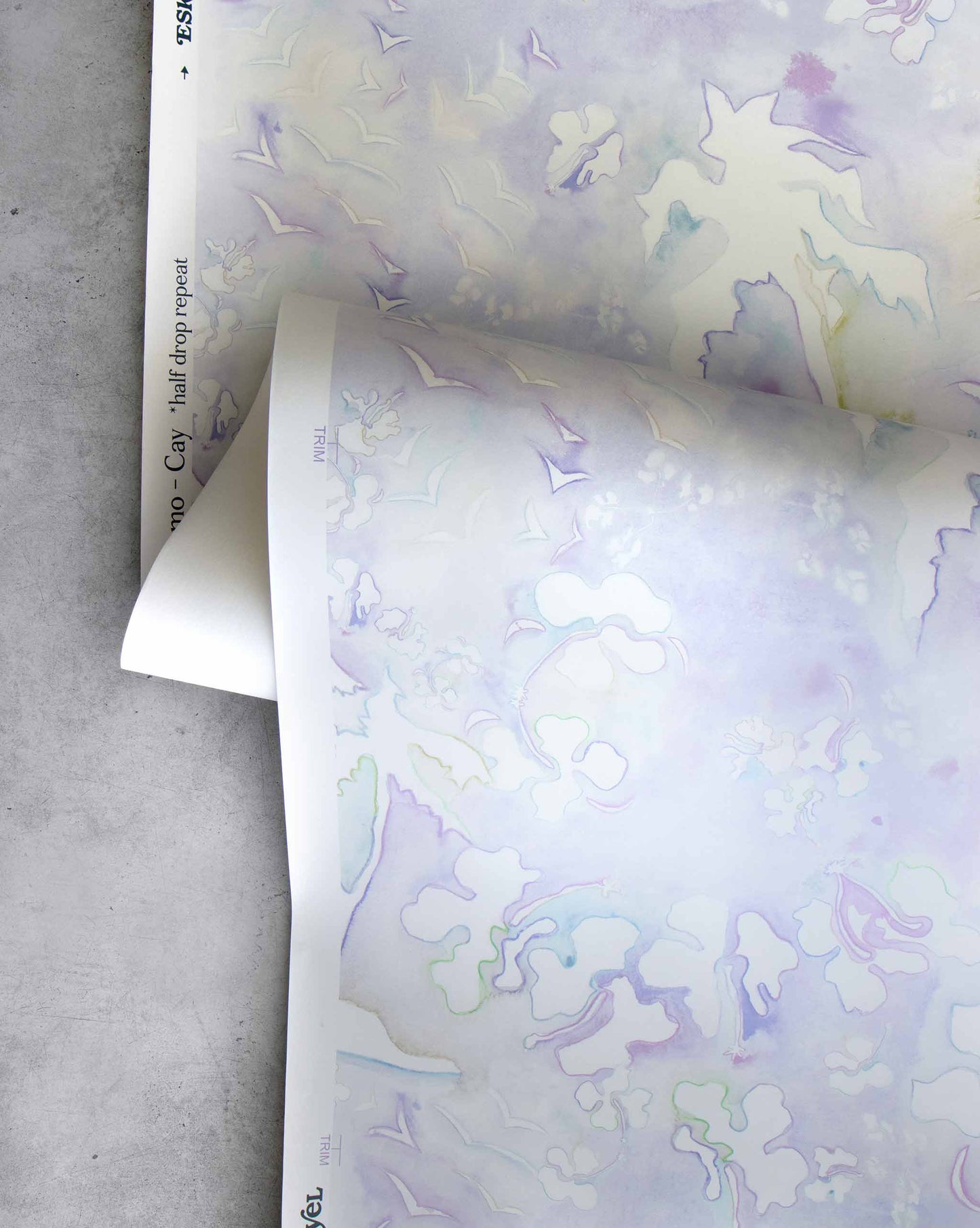 An image of Kokomo Cay Wallpaper with purple tones and a pattern inspired by a tropical landscape of hibiscus lilies, birds, and palm trees using this idea to create one continuing line.