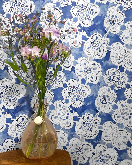 Loosely painted from heirloom lace, Margherita in Fresco Blue is a medium-sized repeat wallpaper in a blue palette.
