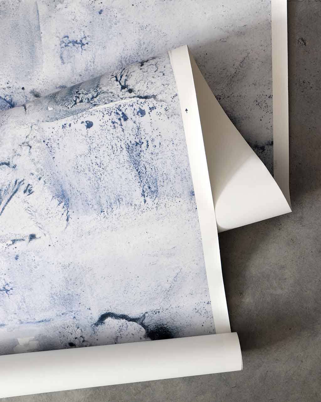 A roll of Melting Checks Wallpaper Ocean, showcasing a playful spirit in the Ocean colorway