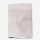 A piece of Mod Mural Wallpaper Shell with a pink background featuring subtle shapes and an abstract design
