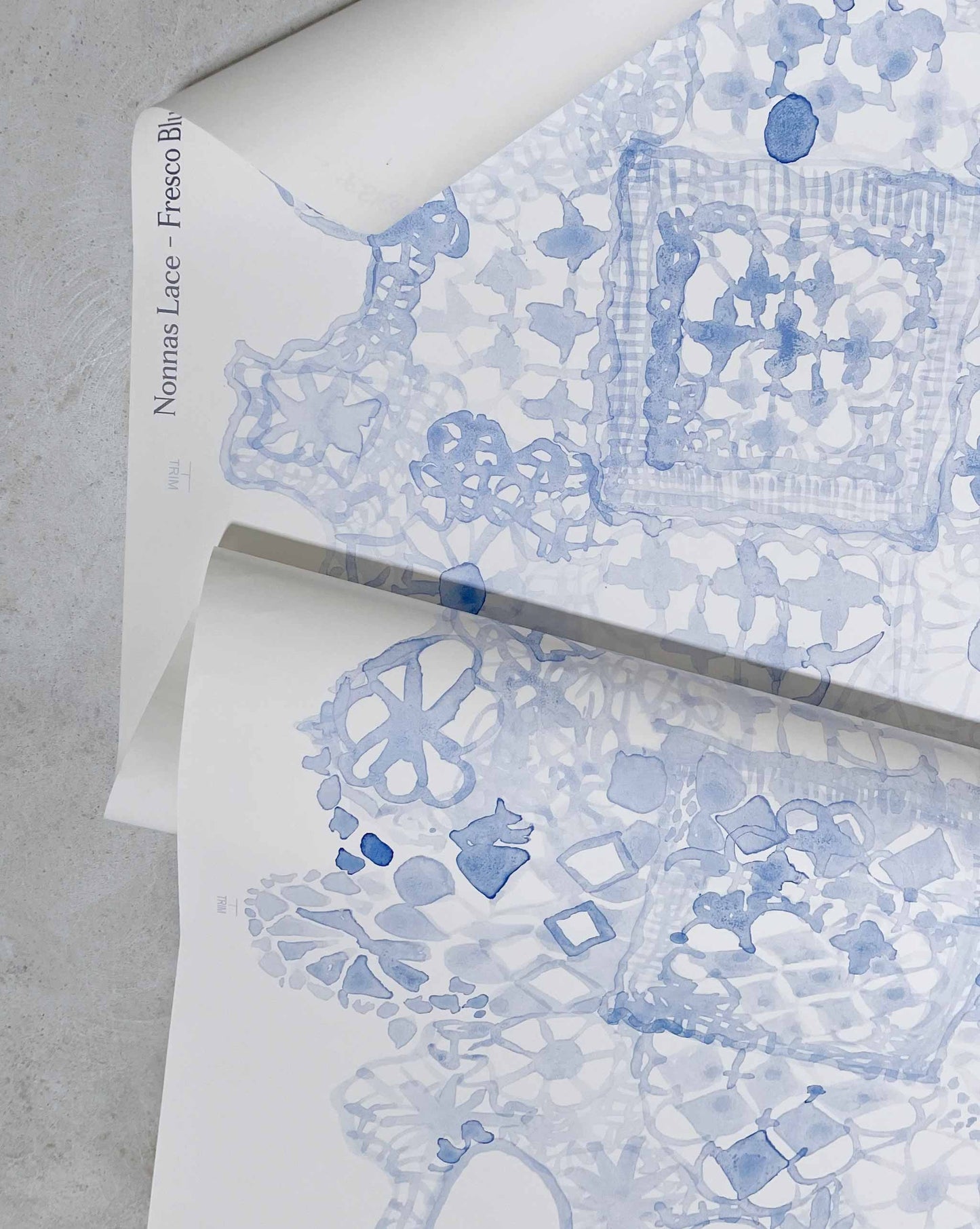 Based on an heirloom lace pattern, Nonna’s Lace in Fresco Blue is a large-scale non-repeating wallpaper in blue tones.
