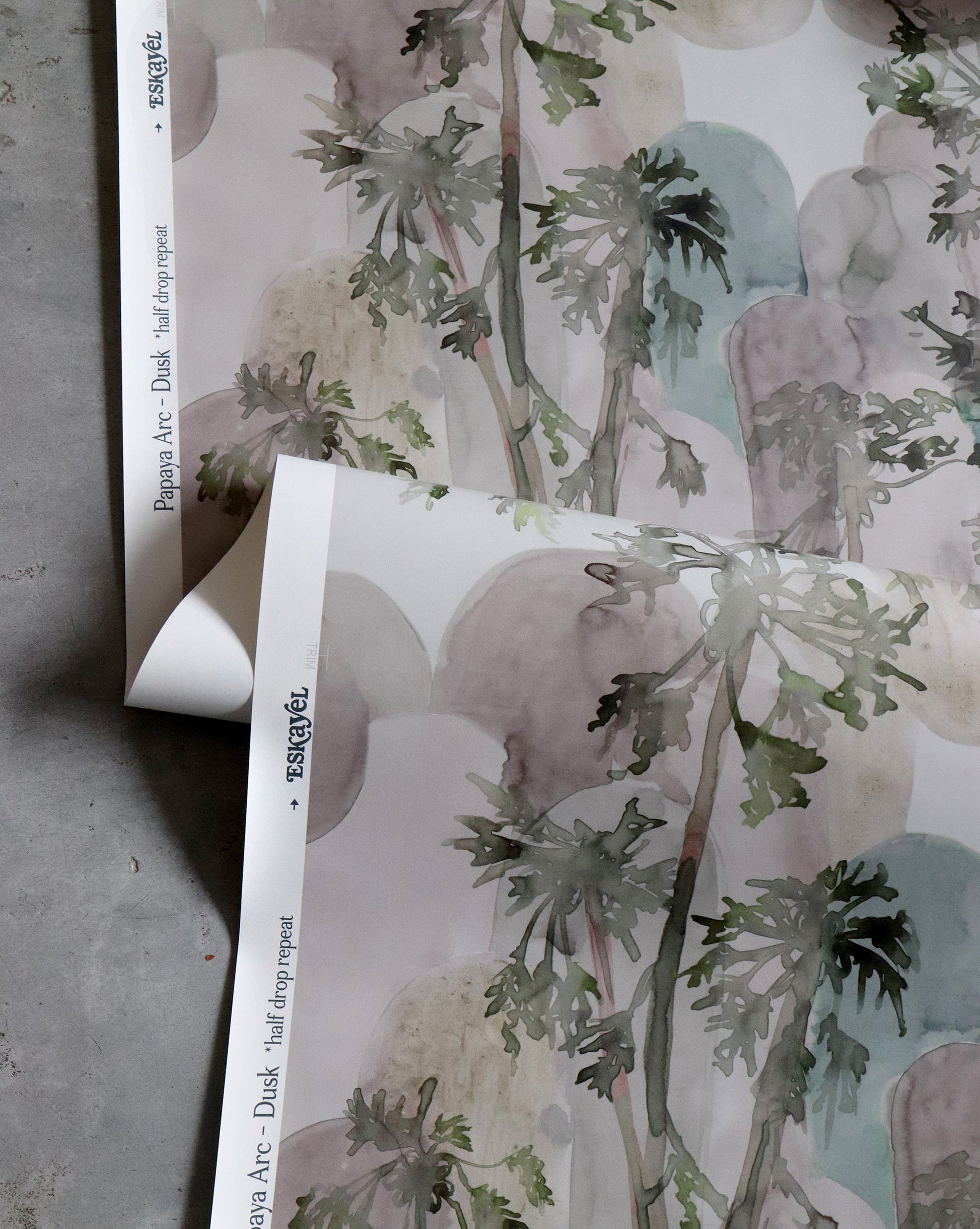 A piece of Papaya Arc Wallpaper Dusk with a print of a palm tree on it