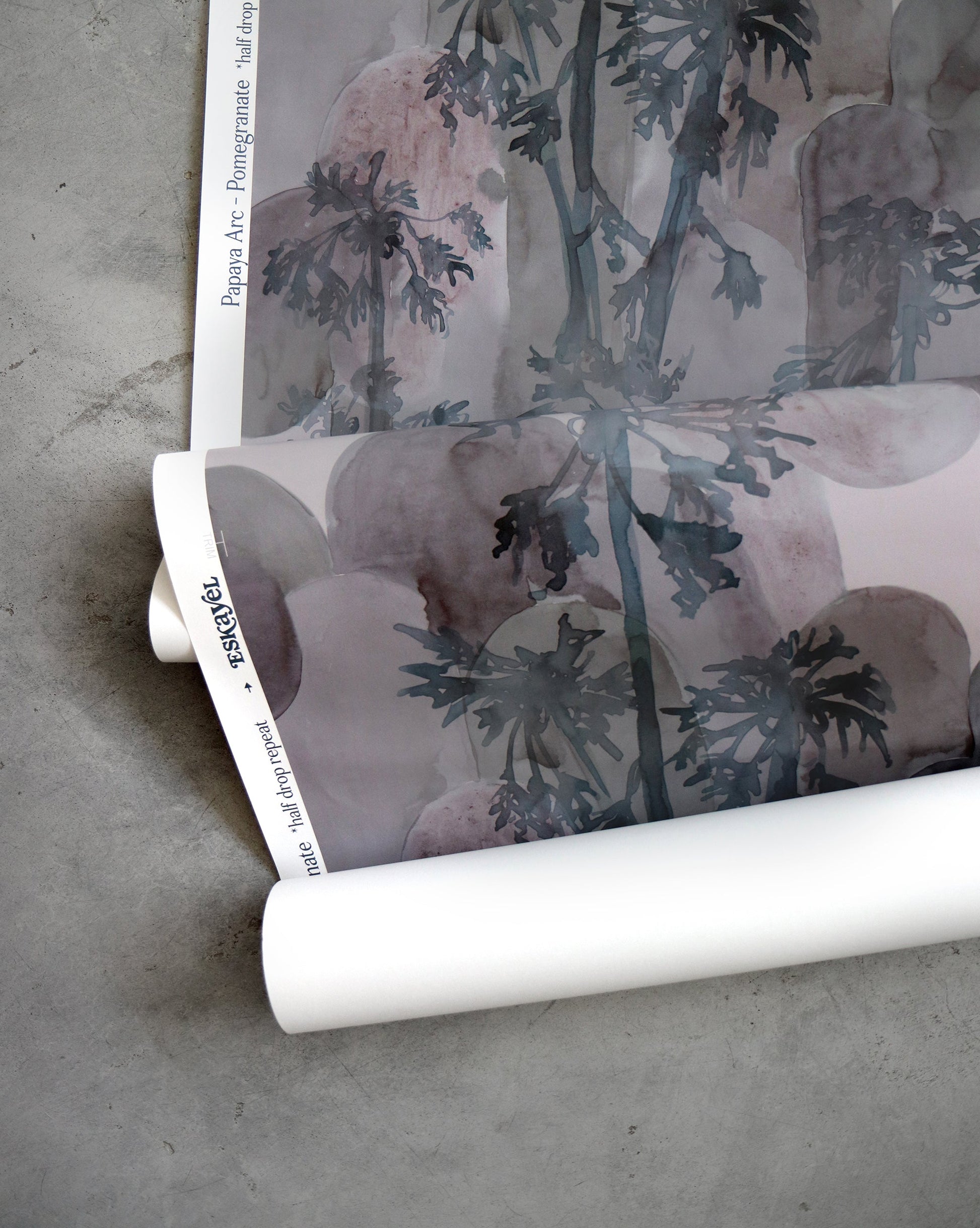 A roll of Papaya Arc Wallpaper with palm trees on it, perfect for adding a touch of the tropics to any space