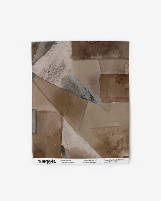 Our Pieces Wallpaper in Garnet has a design of puzzle pieces with color blocking in shades of earthy brown.