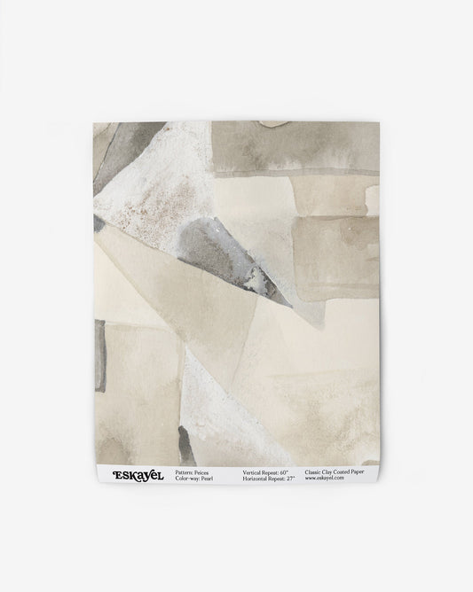 Our Pieces Wallpaper in Pearl has a design of color blocked puzzle pieces in yellow and beige shades.