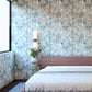 A bedroom with a pink bed and Sorisa Wallpaper Sage chevron wallpaper