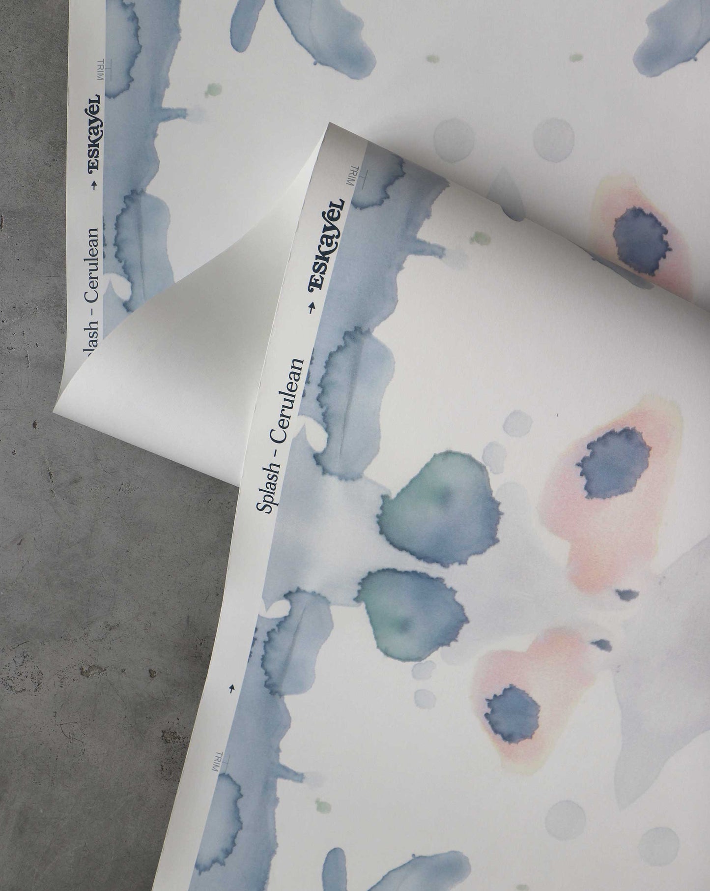 A detail shot of Eskayel's Splash Wallpaper in the colorway Cerulean with a navy blue and peach watercolor design.
