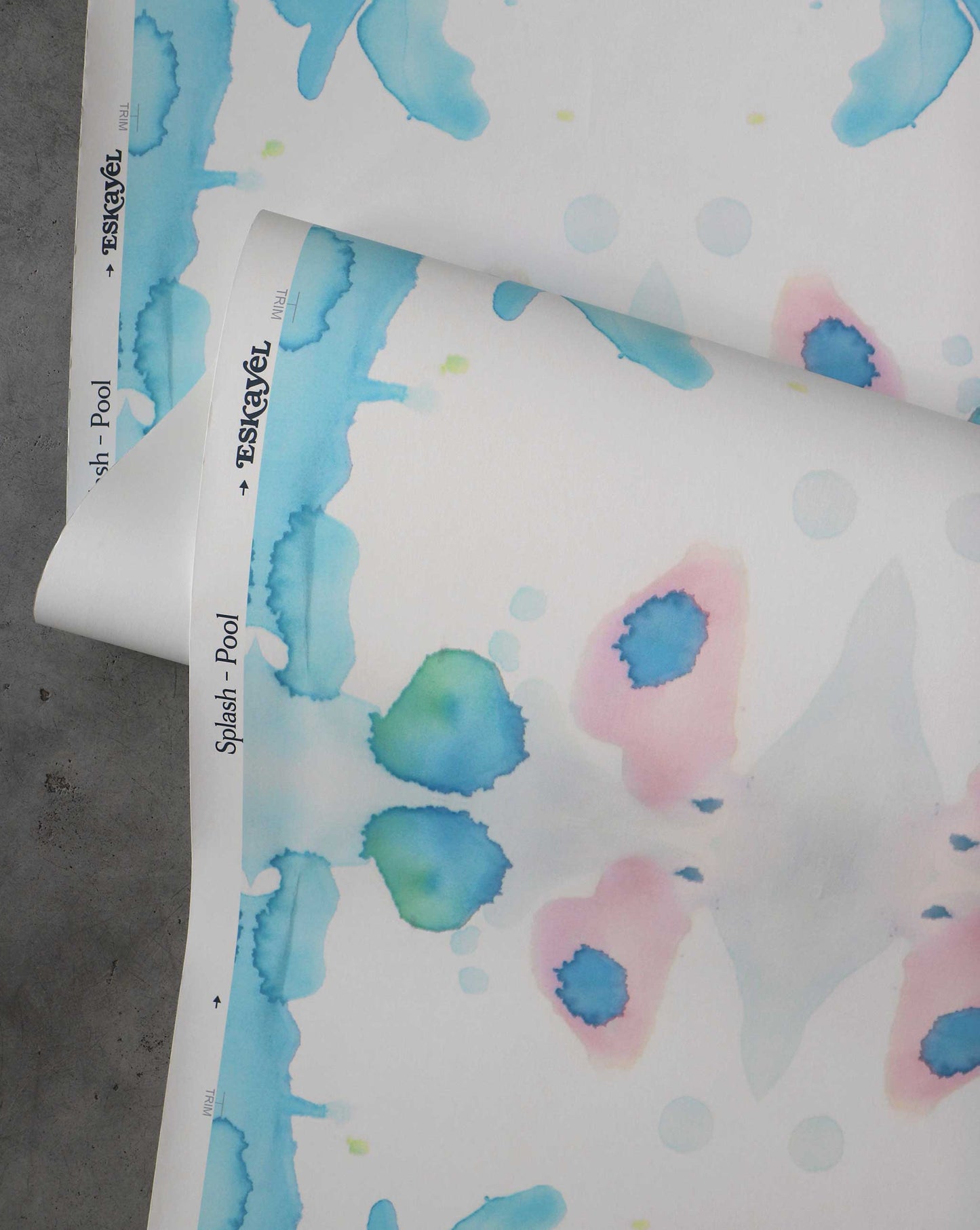 A detail shot of Eskayel's Splash Wallpaper in the colorway Pool with a blue and peach watercolor design.